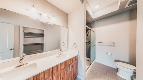 A bathroom with a white countertop and a white toilet.