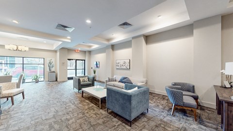 A living room with a grey sofa and a wooden table.