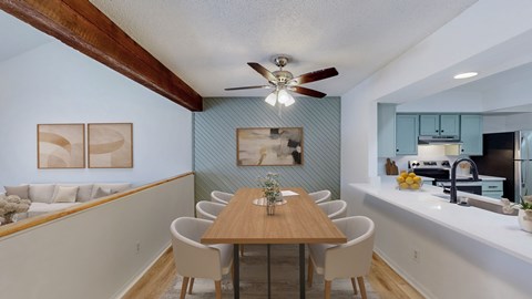 A dining room with a table and chairs.