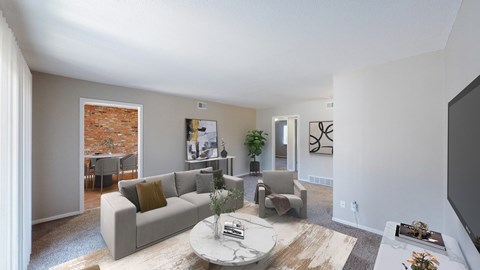 A living room with a grey couch and a coffee table.