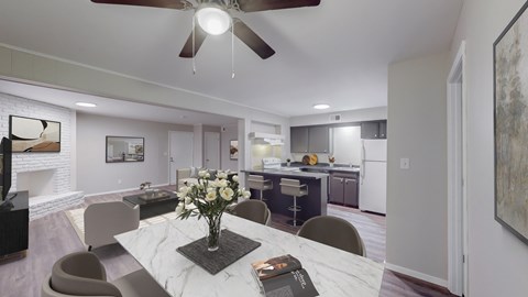 A modern dining room with a marble table and a ceiling fan.