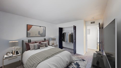 A bedroom with a large bed and a wardrobe.
