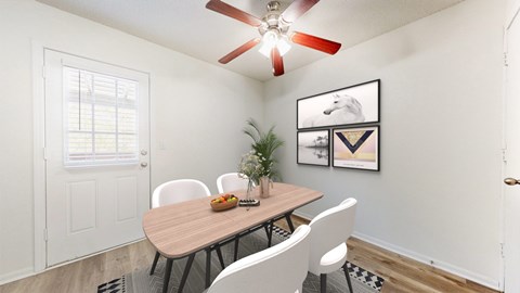 A dining room with a table, chairs, and a ceiling fan.