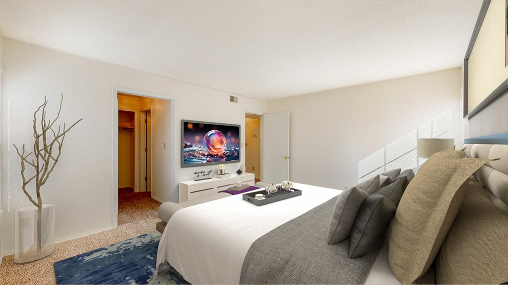 a bedroom with a bed and a tv on the wall