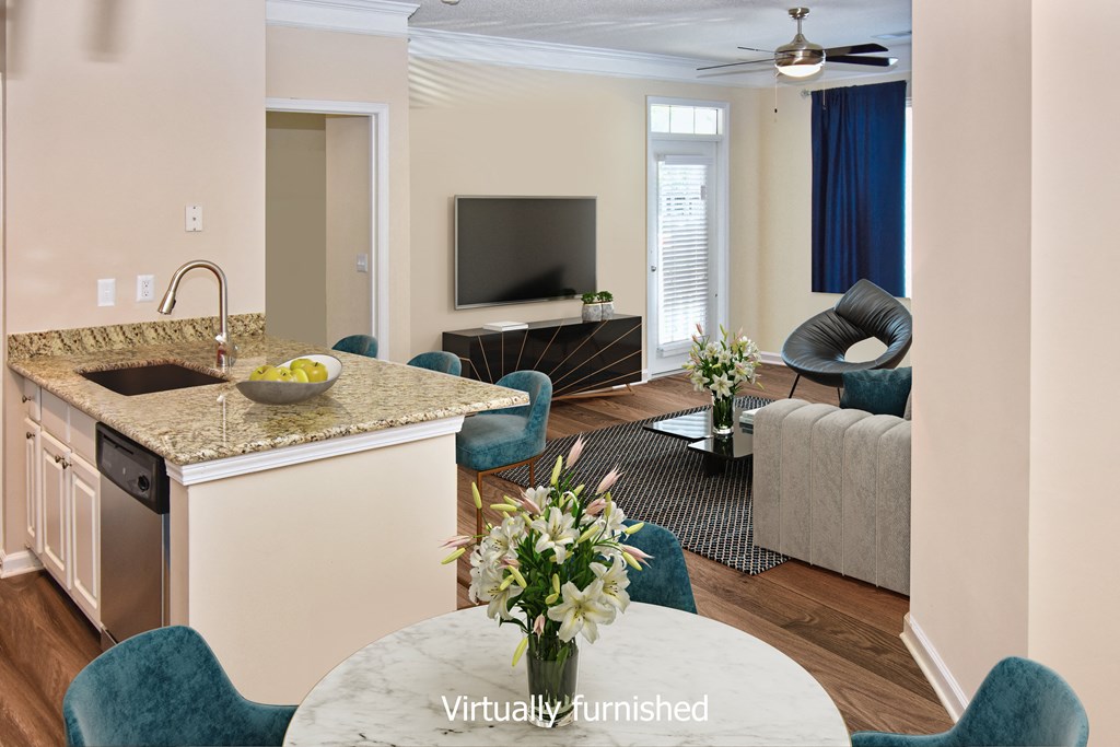 a kitchen and living room with a couch and a tv