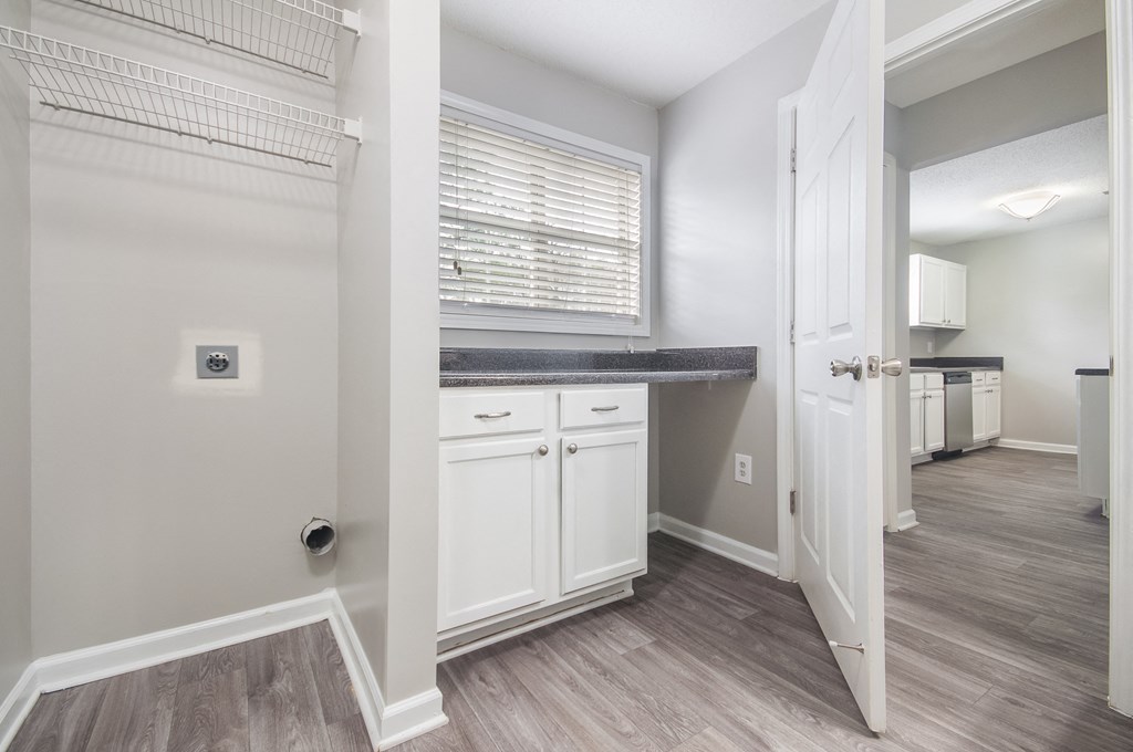 a renovated kitchen with white cabinets and a sink and a window