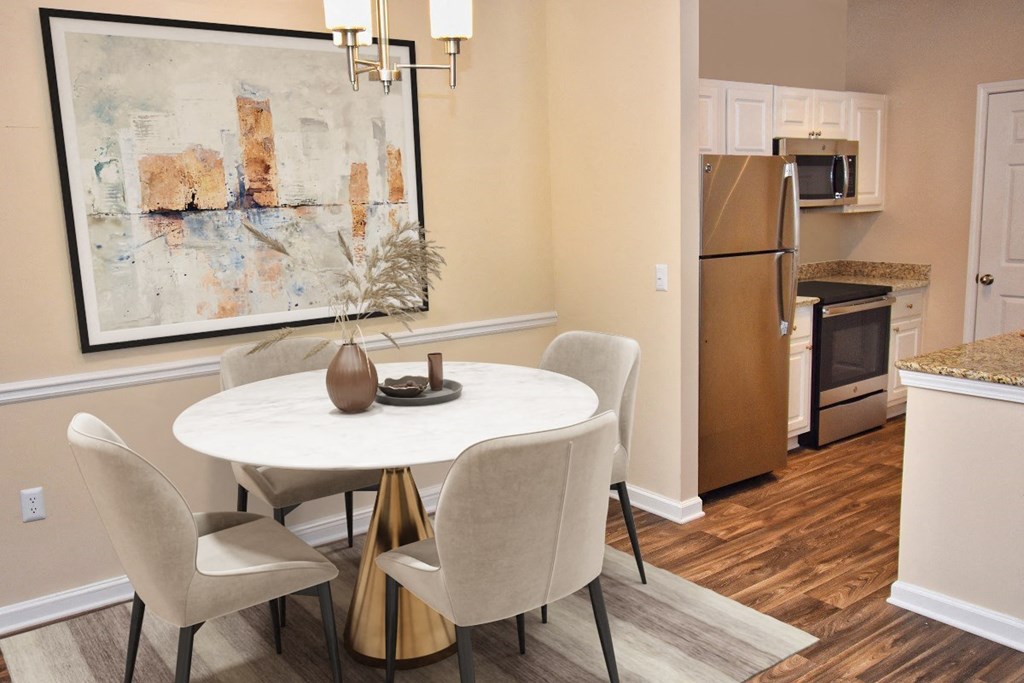 a dining room with a table and chairs and a kitchen with a refrigerator