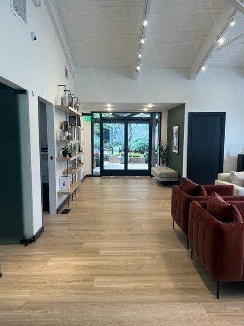 a living room with red couches and a wood floor