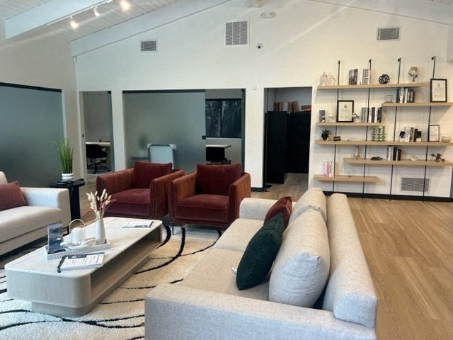 a living room with couches and chairs and a table