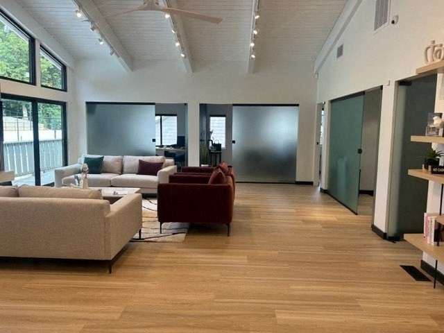 a large living room with couches and a chair