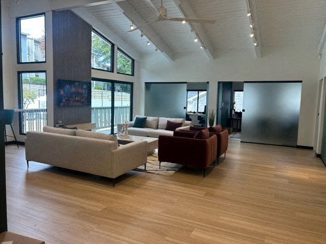 a large living room with couches and chairs