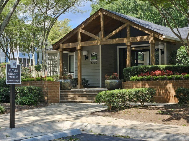 a small house with a sign in front of it