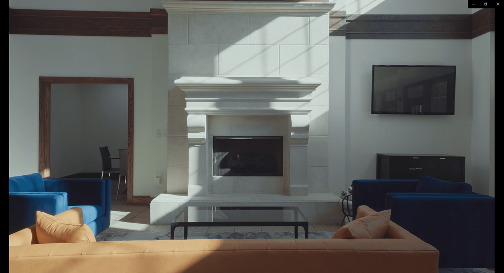 a living room with a fireplace and blue furniture