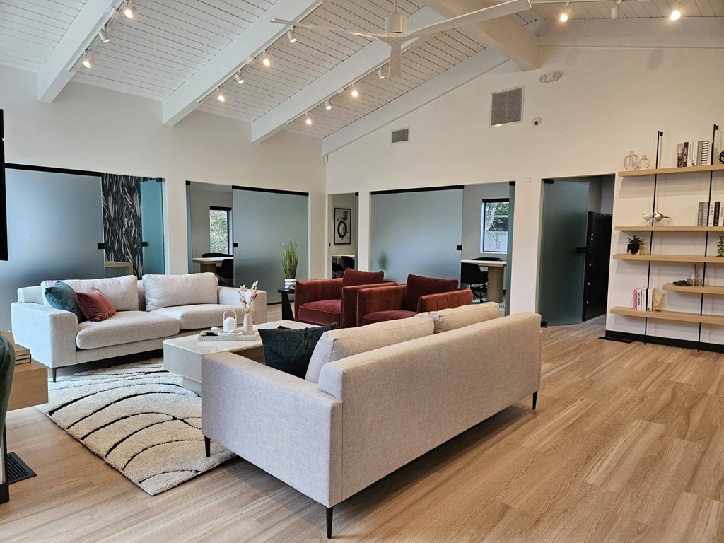 a living room with couches and chairs and a rug
