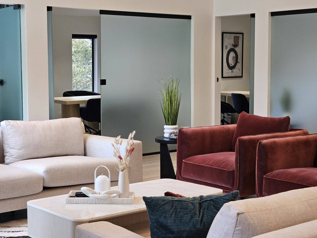 a living room with couches and chairs and a coffee table