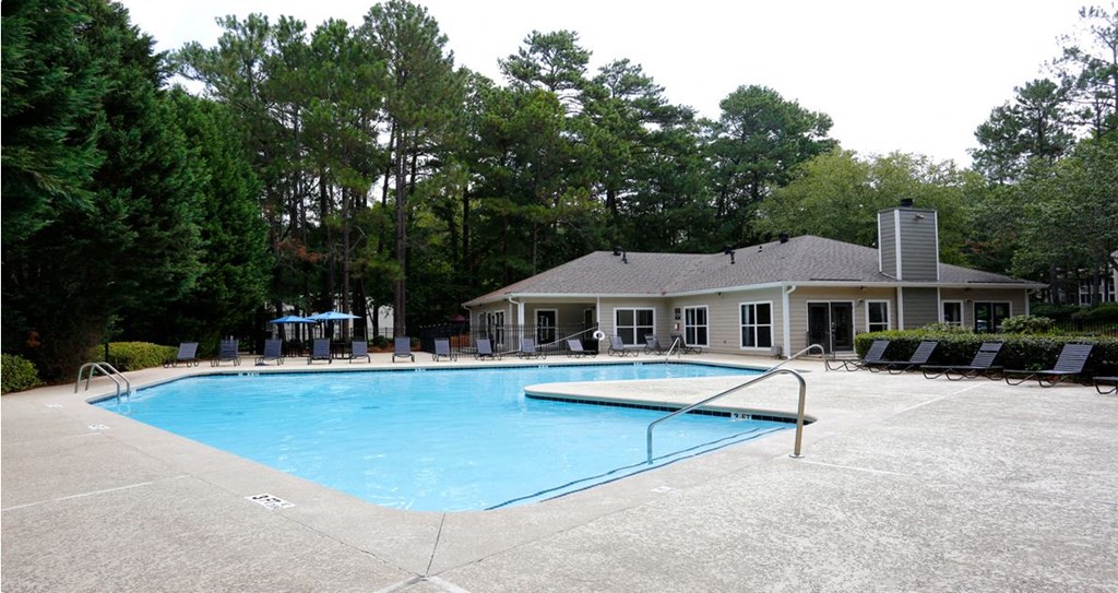 a large swimming pool in front of a house