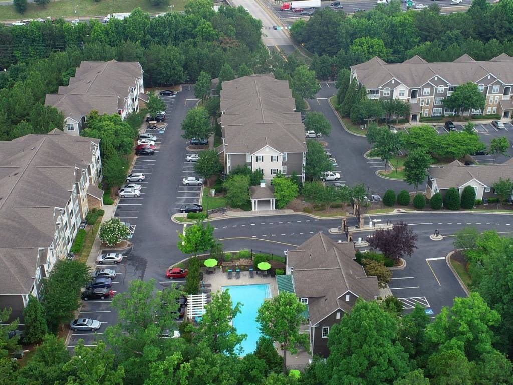 an aerial view of a neighborhood with houses and a swimming pool