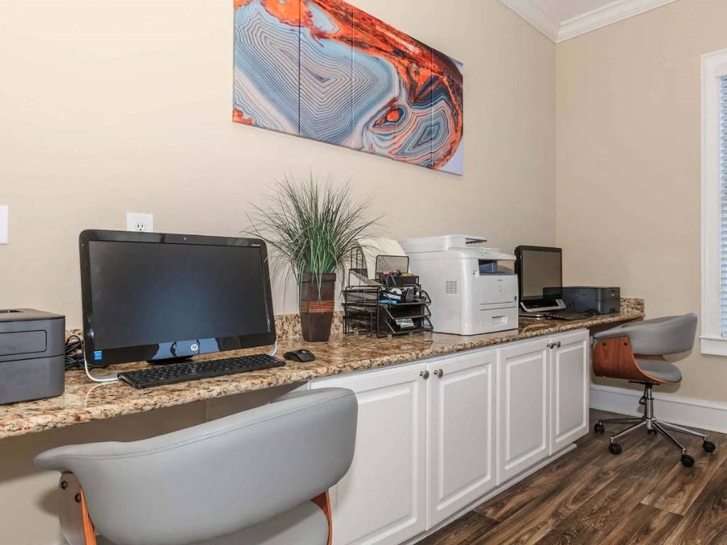 a desk with a computer and a printer on it