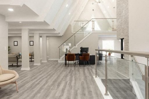 a large living room with a piano and a staircase