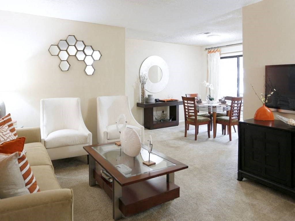 a living room and dining room with a couch and a table