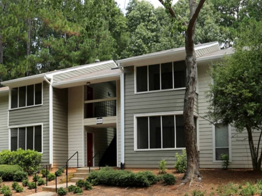 a gray house with a tree in front of it