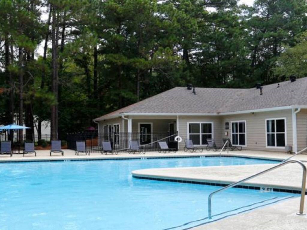 a swimming pool with a building in the background