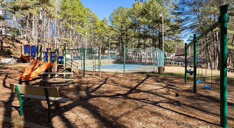 a park with a playground and a tennis court
