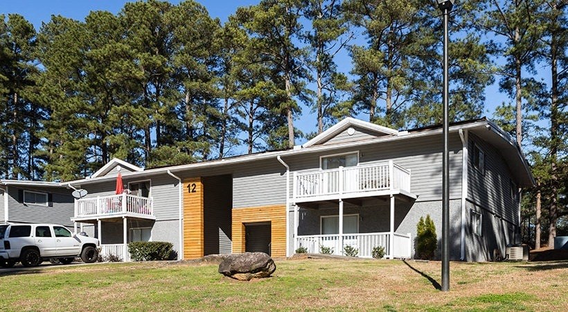 a house with a porch and a car parked in front of it
