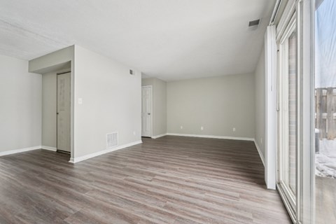 A room with wood flooring and white walls.