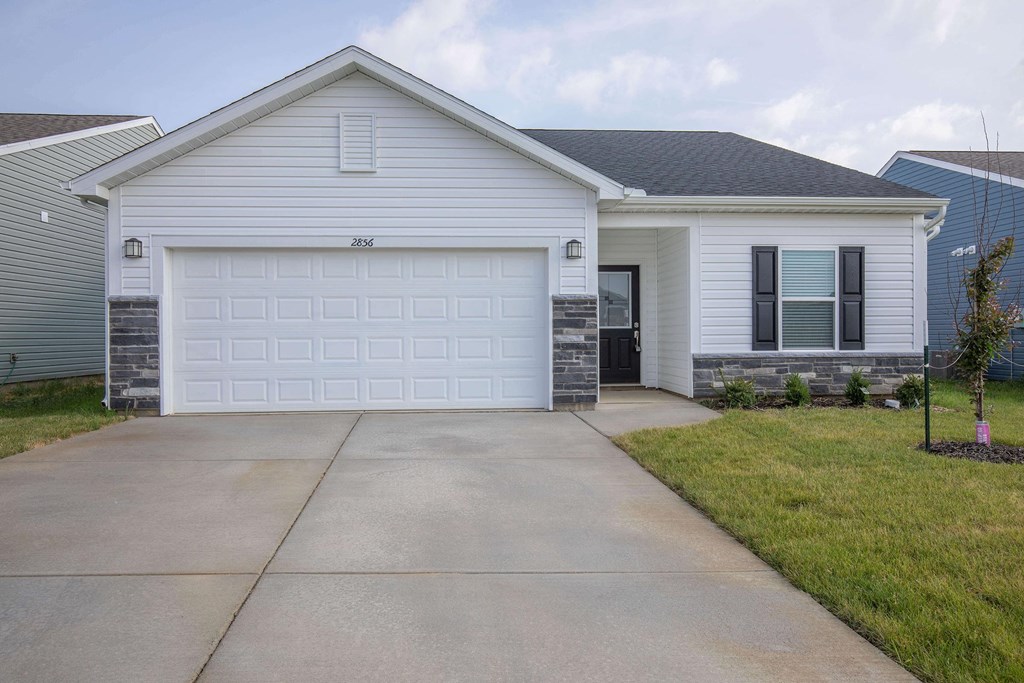 a white house with a white garage door