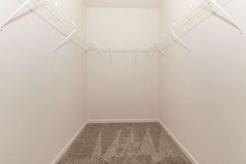 Empty room with a carpeted floor and white walls.