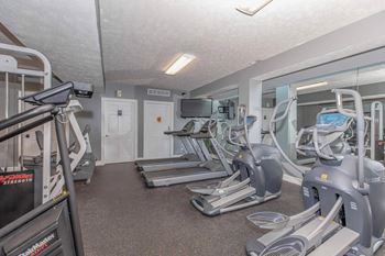 A gym with treadmills and elliptical machines.