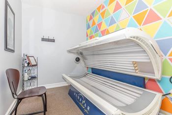 A room with a white wall and a chair.