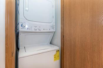 A white washing machine with a yellow sticker on the door.