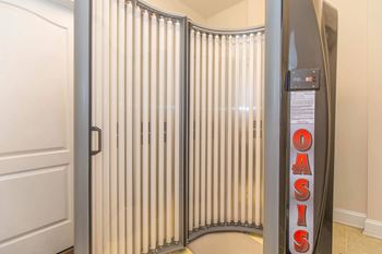 A room with a white door and a wall with a sign that says OASIS.