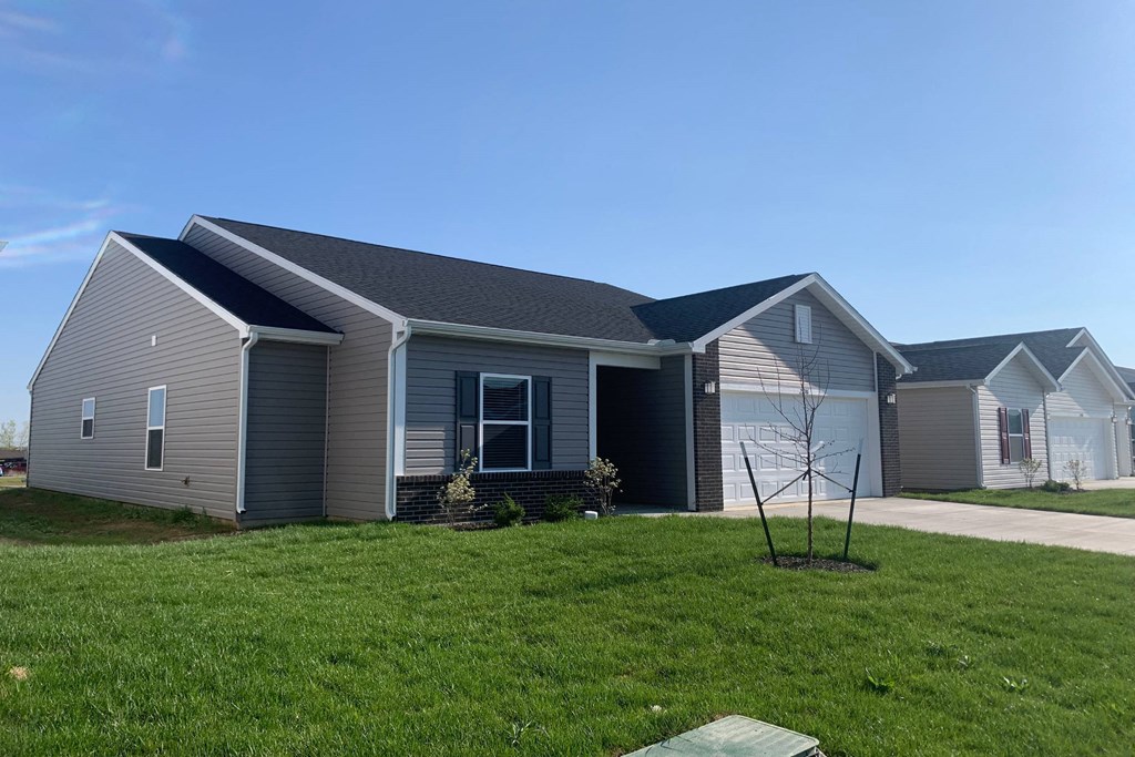a house with gray siding and a gray garage
