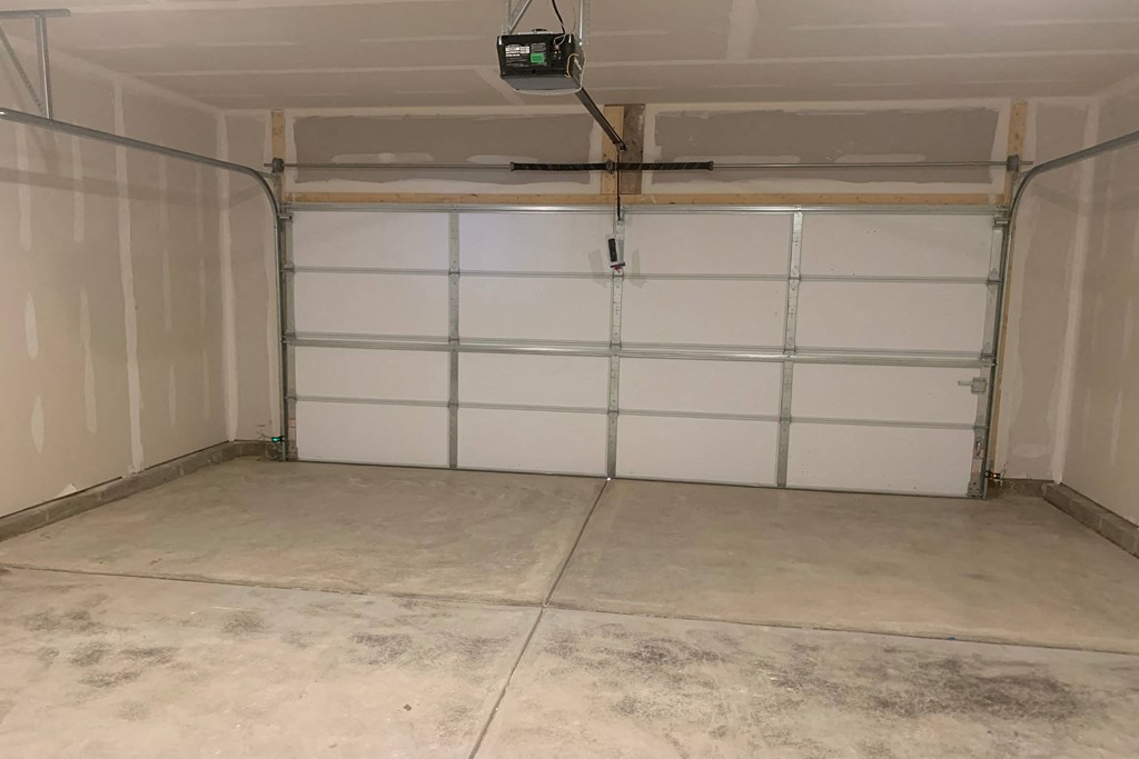 a garage with white walls and a concrete floor