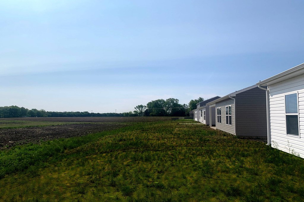 a row of mobile homes in a field