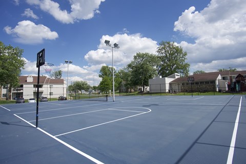 A basketball court with a basketball hoop and a sign on the side.