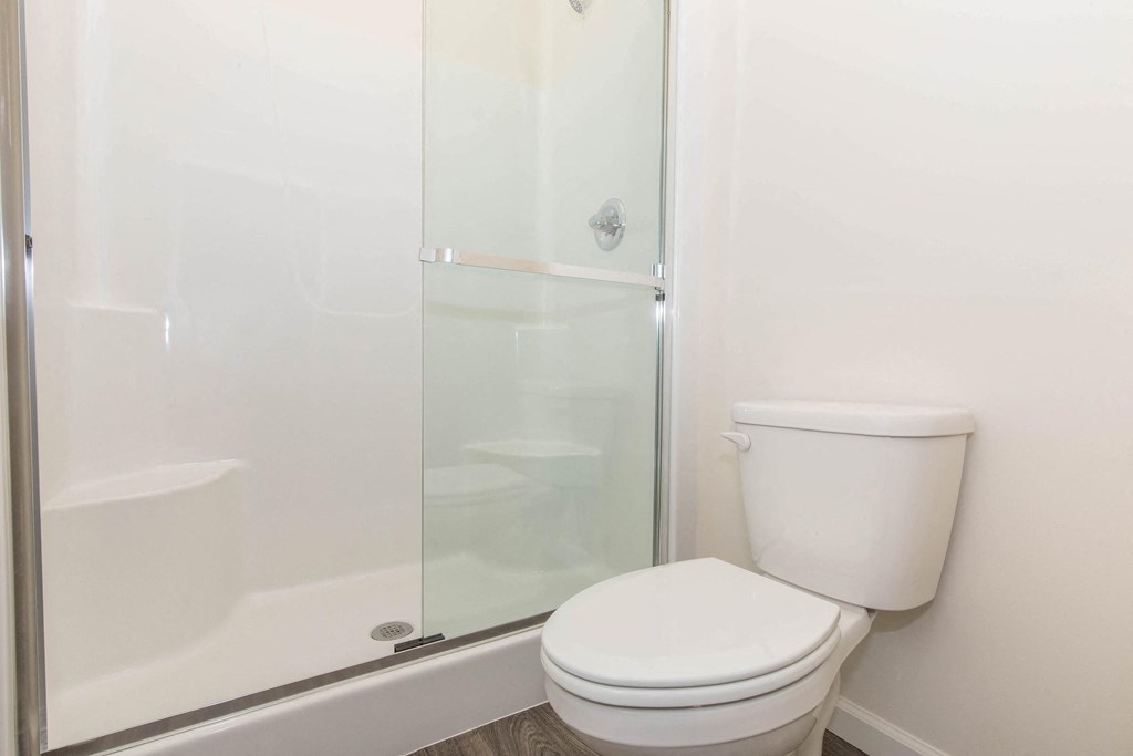 a bathroom with a shower and toilet in a 555 waverly unit