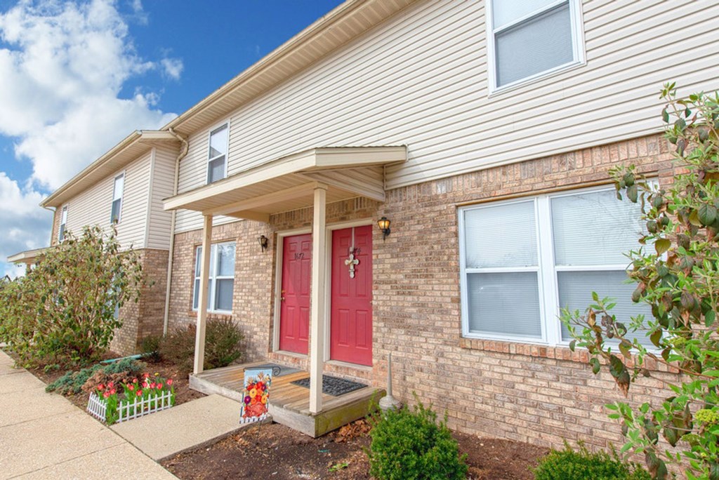 A house with a red door and a porch.