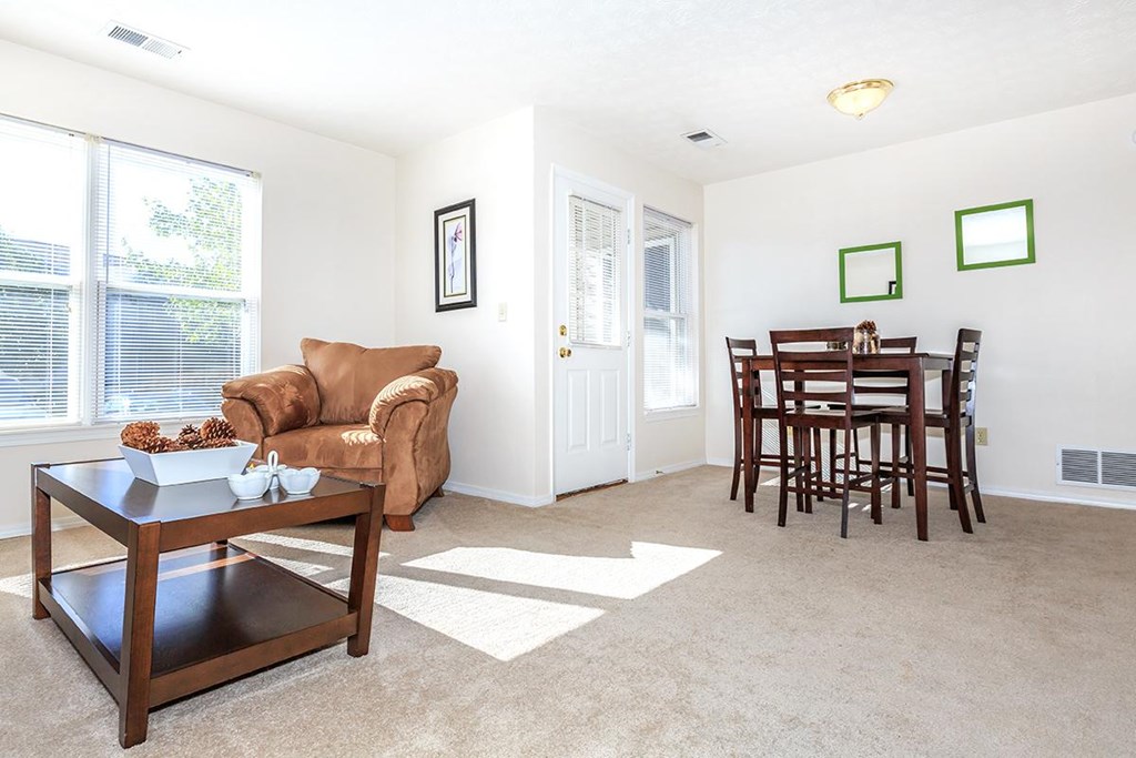 A living room with a brown chair and a coffee table.