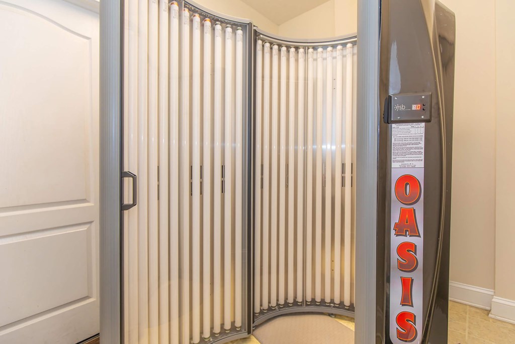 A room with a white door and a wall with a sign that says Oasis.