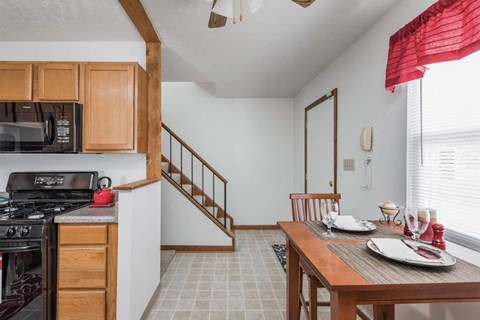 A dining room with a table set for two.