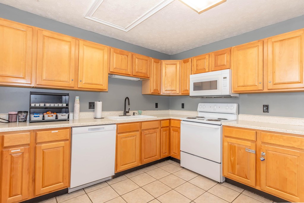 A kitchen with wooden cabinets and white appliances.