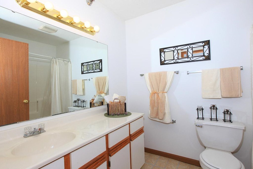 A bathroom with a white toilet and a white sink.