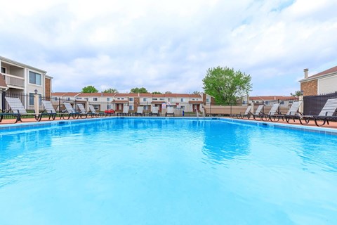 A large swimming pool with a blue tinted water.