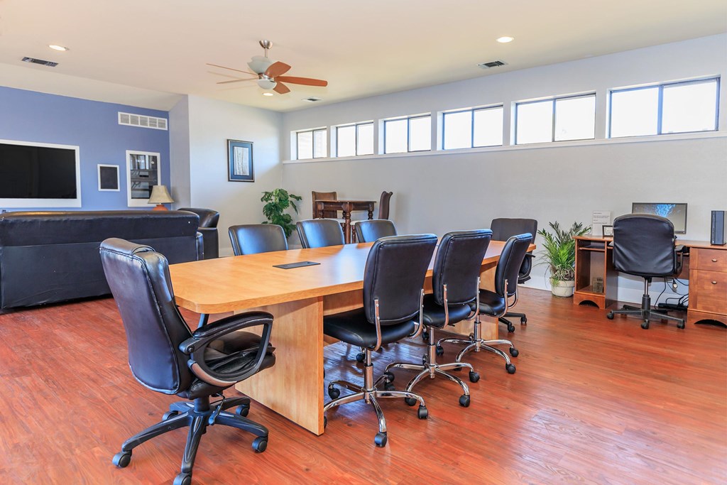 A conference room with a long table and chairs.