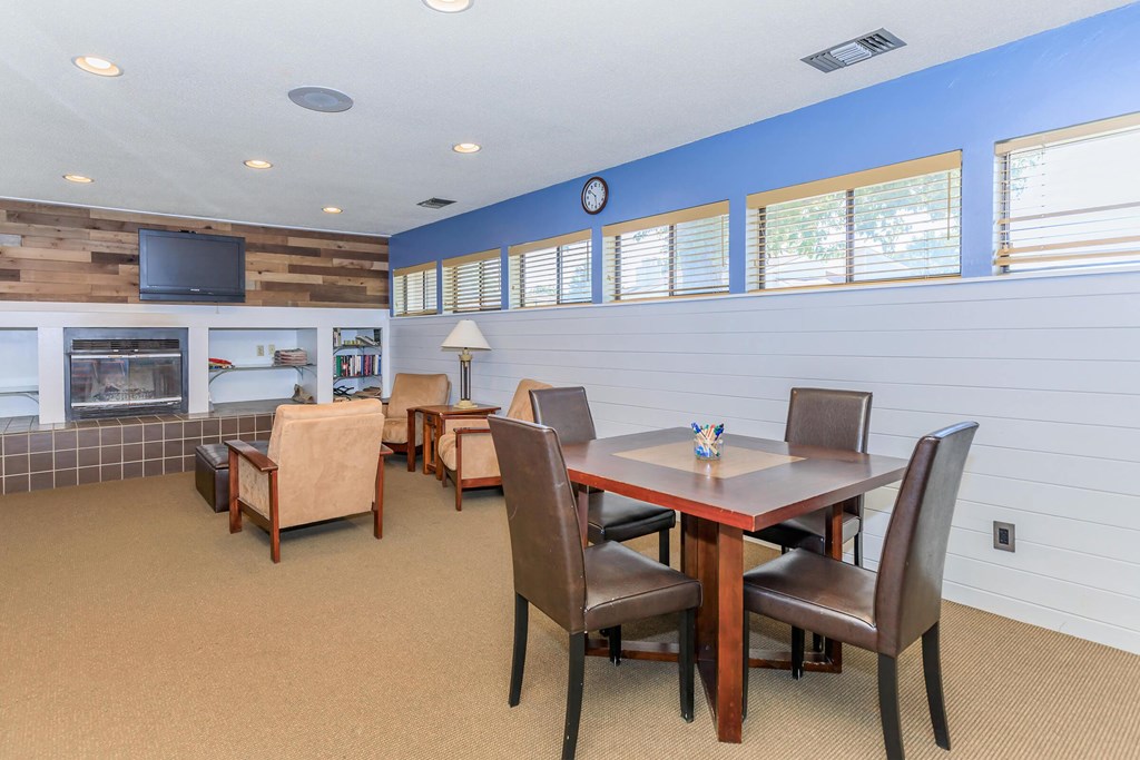 A dining room with a wooden table and chairs.