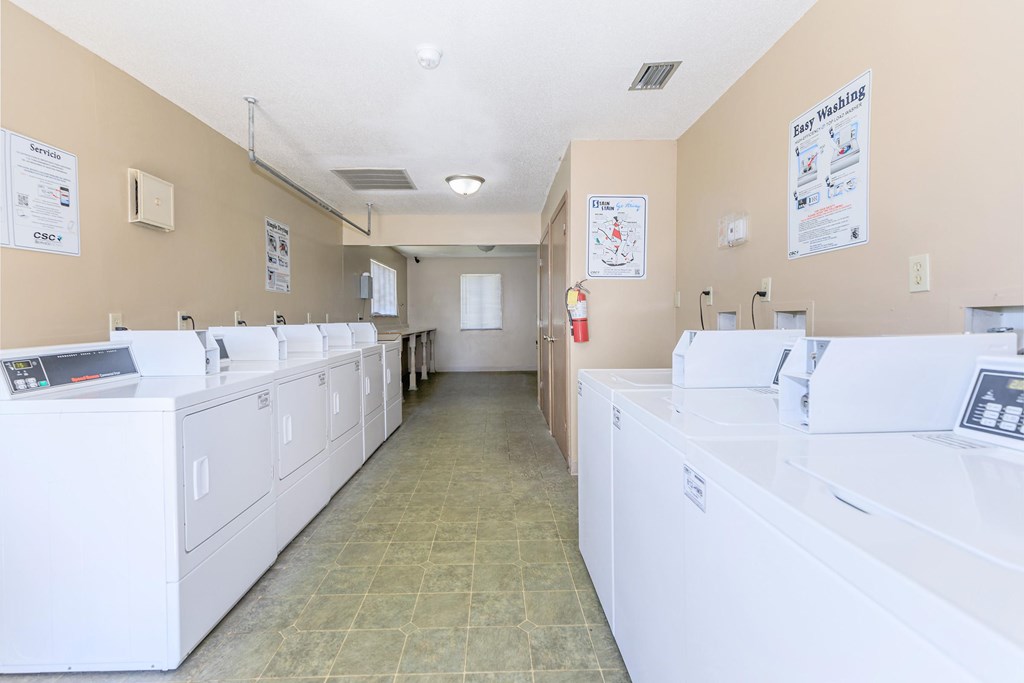 A laundromat with rows of washers and dryers.